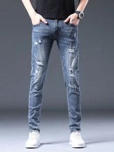 Men’s slim fit distressed blue jeans with ripped details and faded wash in a cotton blend fabric