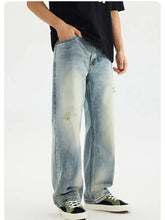 Men’s distressed vintage wash light-wash denim jeans with loose fit, faded patches, and subtle rips