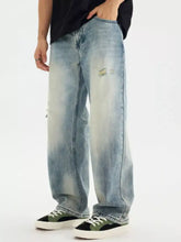 Men’s light-wash denim jeans with a faded distressed vintage wash and subtle embroidery on the thigh in loose fit