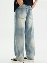 Men’s distressed vintage wash light-wash denim jeans with wide-leg relaxed fit and subtle fading for casual wear