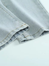 Men’s distressed wash jeans in light-wash denim with subtle fading and reinforced stitching on folded hem