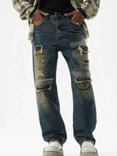 Men’s dark blue denim relaxed fit wide leg jeans with distressed wash featuring intentional rips and patches