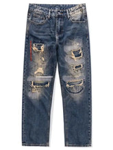 Men’s distressed wash blue denim jeans with relaxed fit and wide leg featuring intentional rips and frayed edges