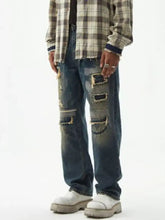 Men’s relaxed fit wide leg jeans in distressed wash blue denim with intentional rips and frayed edges