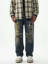 Men’s distressed wash relaxed fit wide leg dark blue denim jeans with intentional ripped patches and frayed edges