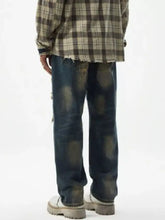 Men’s dark-wash denim relaxed fit wide leg jeans with distressed wash patches and frayed hems