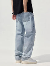 Men’s distressed washed wide leg jeans in light-wash denim with relaxed fit and frayed hems shown from the back