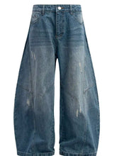 Men’s blue denim jeans with wide leg cut and distressed details featuring a relaxed baggy fit