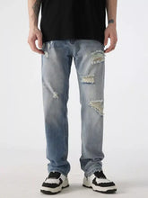 Men’s light-wash denim distressed wide leg jeans with frayed patches on thighs and knees
