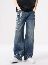 Men’s distressed wide leg jeans in blue denim with ripped details and a relaxed wide leg cut