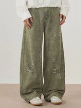Men’s olive green distressed wide leg denim jeans with faded wash and intentional rips for casual wear