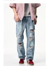 Men’s distressed wide leg light-wash denim jeans with ripped knees and frayed edges in cotton material