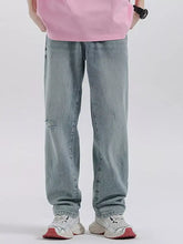 Men’s light-wash denim wide leg jeans with relaxed straight cut and subtle distressing on the knee