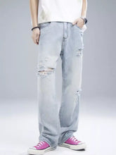 Men’s distressed wide leg light-wash denim jeans with ripped details at the knees and thighs