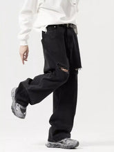 Men’s black distressed denim wide leg jeans with ripped knee detail and wide leg cut