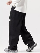 Men’s black distressed wide leg jeans with relaxed fit and frayed tear detail on thigh made of denim material