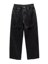 Men’s black distressed wide leg jeans with frayed ripped knees and silver toned hardware in denim material