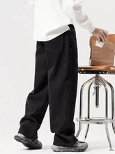 Men’s black wide leg jeans in denim with relaxed fit and visible stitching details for a distressed look