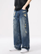 Men’s distressed wide leg jeans in blue denim featuring intentional rips and frayed edges for a casual look