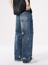 Men’s distressed wide leg jeans in blue denim with ripped details and a relaxed wide leg cut