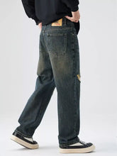 Men’s distressed wide leg dark-wash denim jeans with a faded look and subtle frayed details