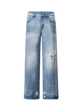Men’s light-wash denim wide leg jeans with intentional distressing at the knees for a stylish casual look