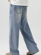 Men’s distressed wide leg jeans in light-wash denim with subtle distressed details and a wide-leg cut