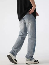 Men’s distressed wide leg jeans in light-wash denim with frayed details and a relaxed fit