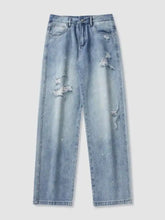 Men’s light-wash denim distressed wide leg jeans with intentional distressing and frayed patches on the thighs