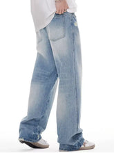 Men’s light-wash denim distressed wide leg jeans with a relaxed fit and subtle distressing details