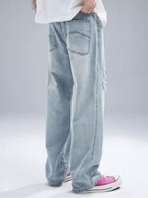 Men’s light-wash denim jeans with a relaxed wide-leg cut and subtle distressed details on the side