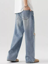 Men’s distressed wide leg light-wash denim jeans with relaxed fit and subtle distressed side seam details