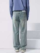Men’s distressed wide leg light-wash denim jeans with a relaxed straight-leg cut and classic back pockets