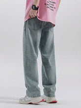 Light-wash denim men’s distressed wide leg jeans with relaxed straight-leg cut and classic back pockets shown from the back