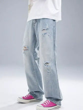Men’s light-wash denim distressed wide leg jeans with ripped details on thighs and knees for casual wear