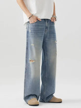 Men’s distressed wide leg jeans in light-wash denim featuring ripped details for a casual look