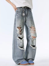 Men’s light-wash denim distressed wide leg jeans featuring ripped knees and frayed edges for casual wear