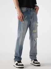 Men’s distressed wide leg jeans in light-wash denim with ripped details and a straight-leg cut displayed from the back side