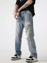 Men’s distressed wide leg jeans in light-wash denim with ripped details and a relaxed fit for casual wear