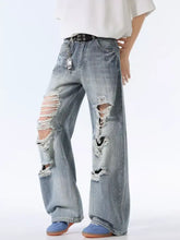 Men’s light-wash denim distressed wide leg jeans with ripped knees and frayed edges