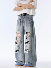 Men’s light-wash distressed wide leg denim jeans with ripped knees and frayed edges