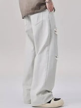 Men’s light-wash distressed wide leg denim jeans with ripped details on the thigh for casual wear