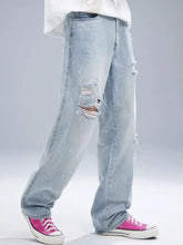 Men’s light-wash denim distressed wide leg jeans with ripped details on the thighs