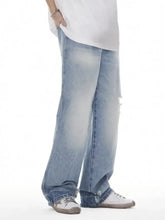 Men’s light-wash distressed denim wide leg jeans with frayed hems and a relaxed fit for casual wear