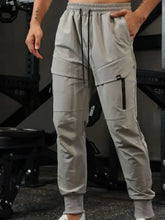 Mens light gray drawstring joggers with cargo pockets and elastic cuffs