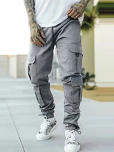 Mens drawstring cargo pants in gray with pockets and white sneakers