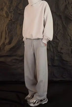 Mens drawstring straight-leg sweatpants in basic style with turtleneck sweatshirt and sneakers