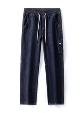 Men’s dark blue denim cargo pants with white drawstrings and a relaxed fit in washed wide leg style