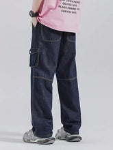 Men’s dark blue denim drawstring wide leg jeans featuring cargo style with reinforced stitching and multiple pockets