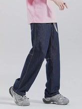 Men’s dark blue denim drawstring washed wide leg jeans with white stitching and a relaxed straight-leg cut